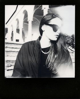Polaroid 600 OneStep held in hand to show size and portable shooting convenience