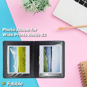 Polaroid album open two-page spread showing protected prints and organization