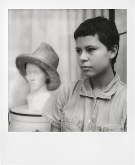 The Imaging World polaroid black & white print developing in hand showing visible image emergence