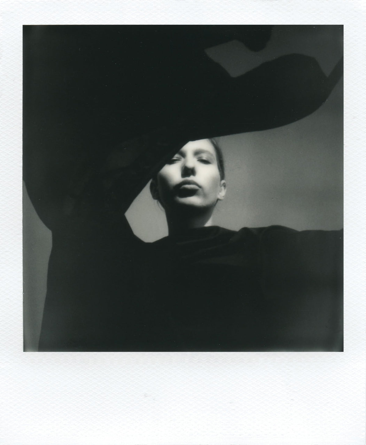 Polaroid B and W I-Type film developing, minutes to reveal classic texture.