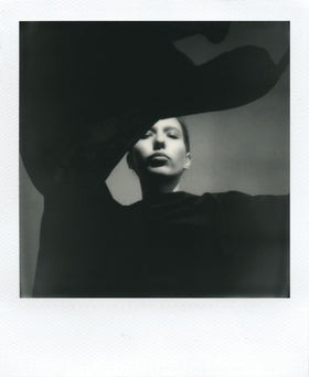 Polaroid B and W I-Type film developing, minutes to reveal classic texture.
