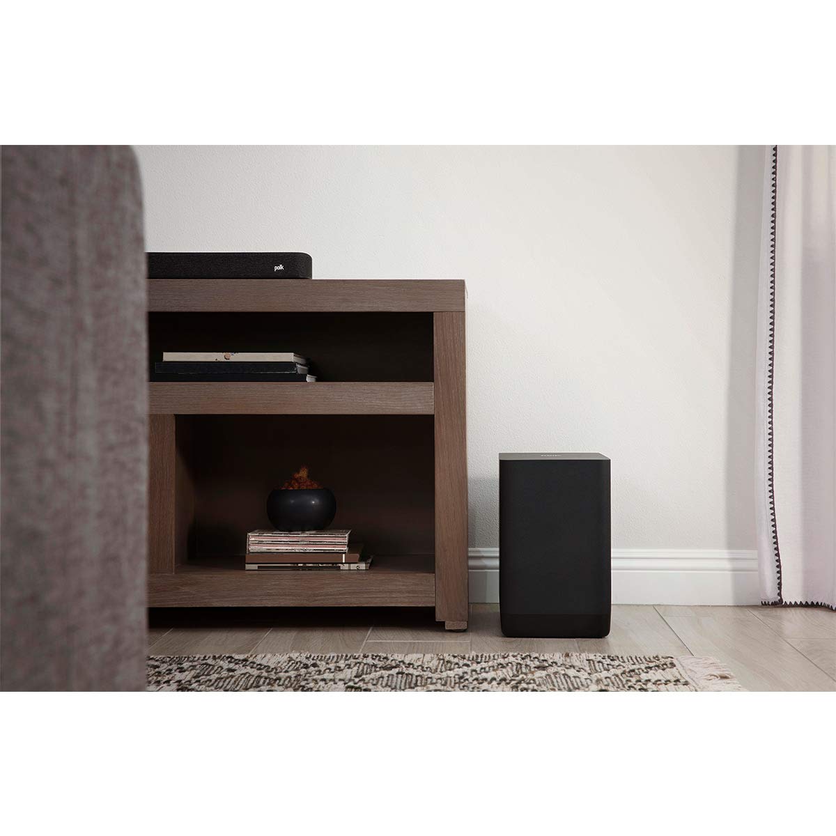 Polk Audio React subwoofer mounted in a home theater setup for cinematic bass