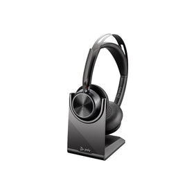 POLY Voyager Focus 2 headset on desk with USB-C adapter for wireless learning