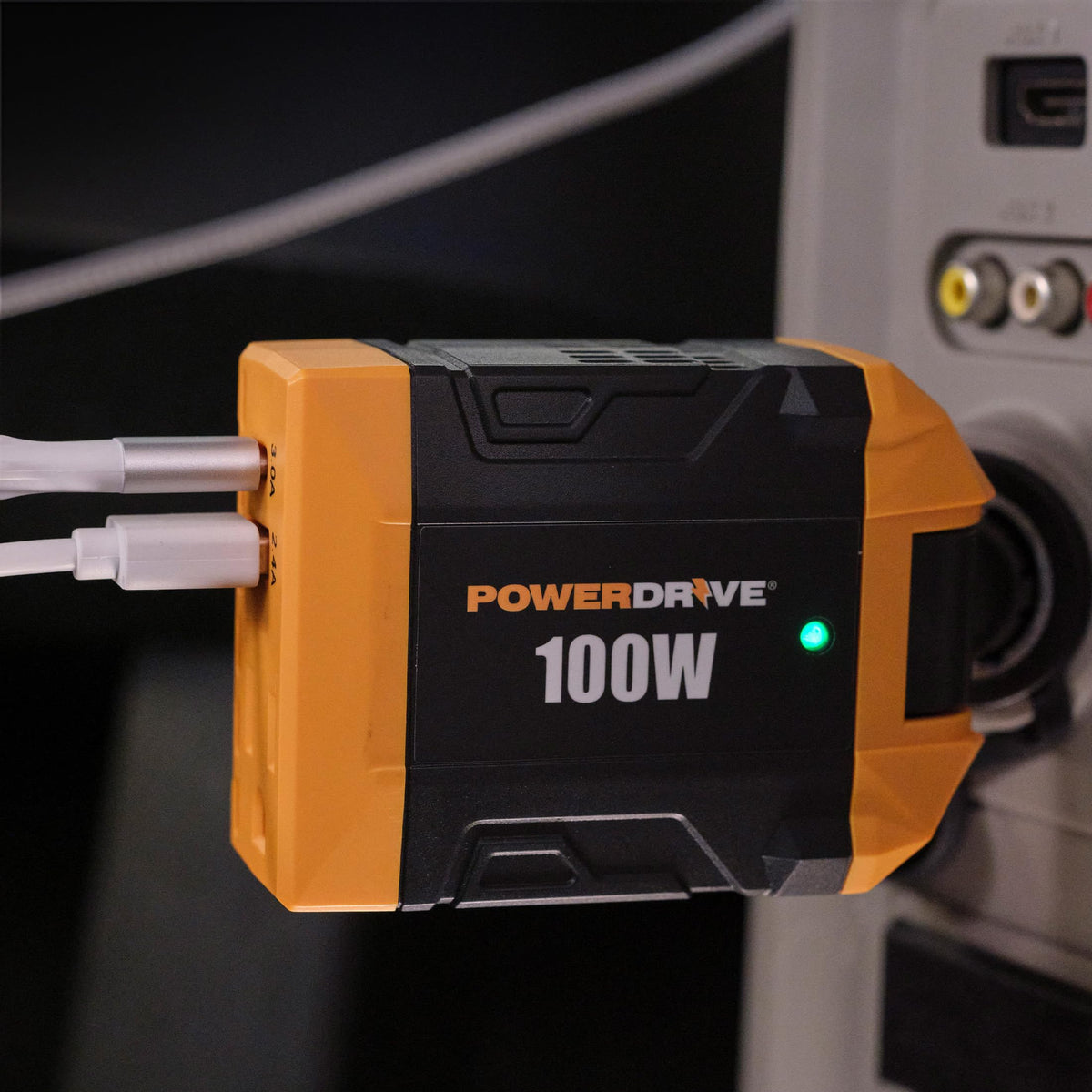 PowerDrive PWD100D plugged into vehicle cigarette socket powering devices while driving