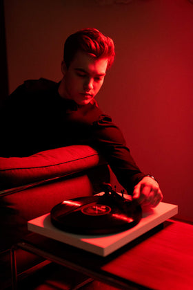 Pro-Ject Debut Carbon EVO gloss white chassis silhouette in a modern room.
