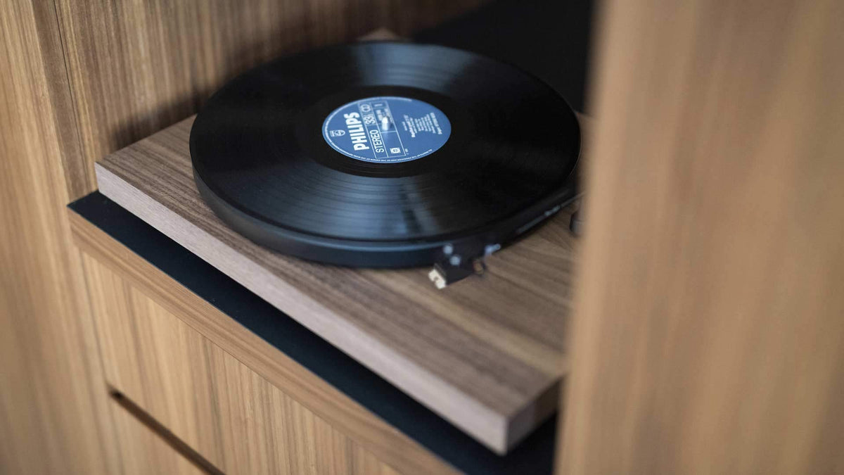 Pro-Ject Debut Carbon EVO walnut tonearm detail highlighting precision