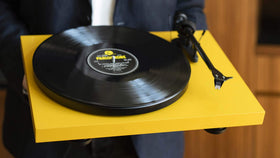 Pro-Ject Debut Carbon EVO Yellow top view shows pre-mounted Sumiko Rainier cartridge for easy setup.