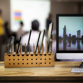 Prosumer's Choice charging station in use on a desk charging multiple phones and tablets