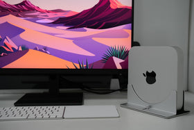 Psitek Mac Mini Stand elevated setup improves airflow and desk organization.