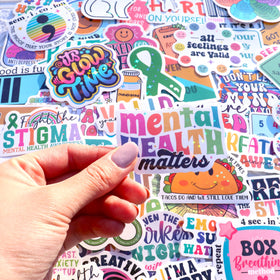 Puraesla stickers on journal enhance mindful journaling with uplifting visuals.