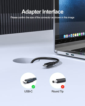 Pwept adapter next to laptop showing compact size and travel convenience