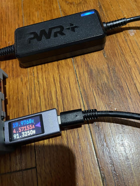 PWR+ powering laptop from back seat demonstrating usable travel convenience