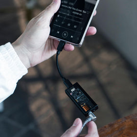 Questyle M15i used in real-world scenarios with mobile devices.
