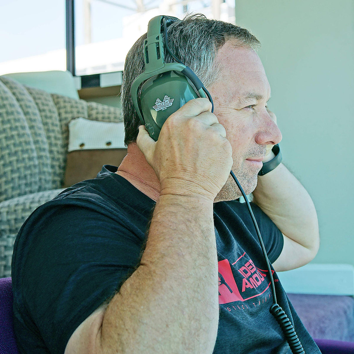 Race Day Electronics RDE-990 worn at shooting range demonstrating protection and audio access