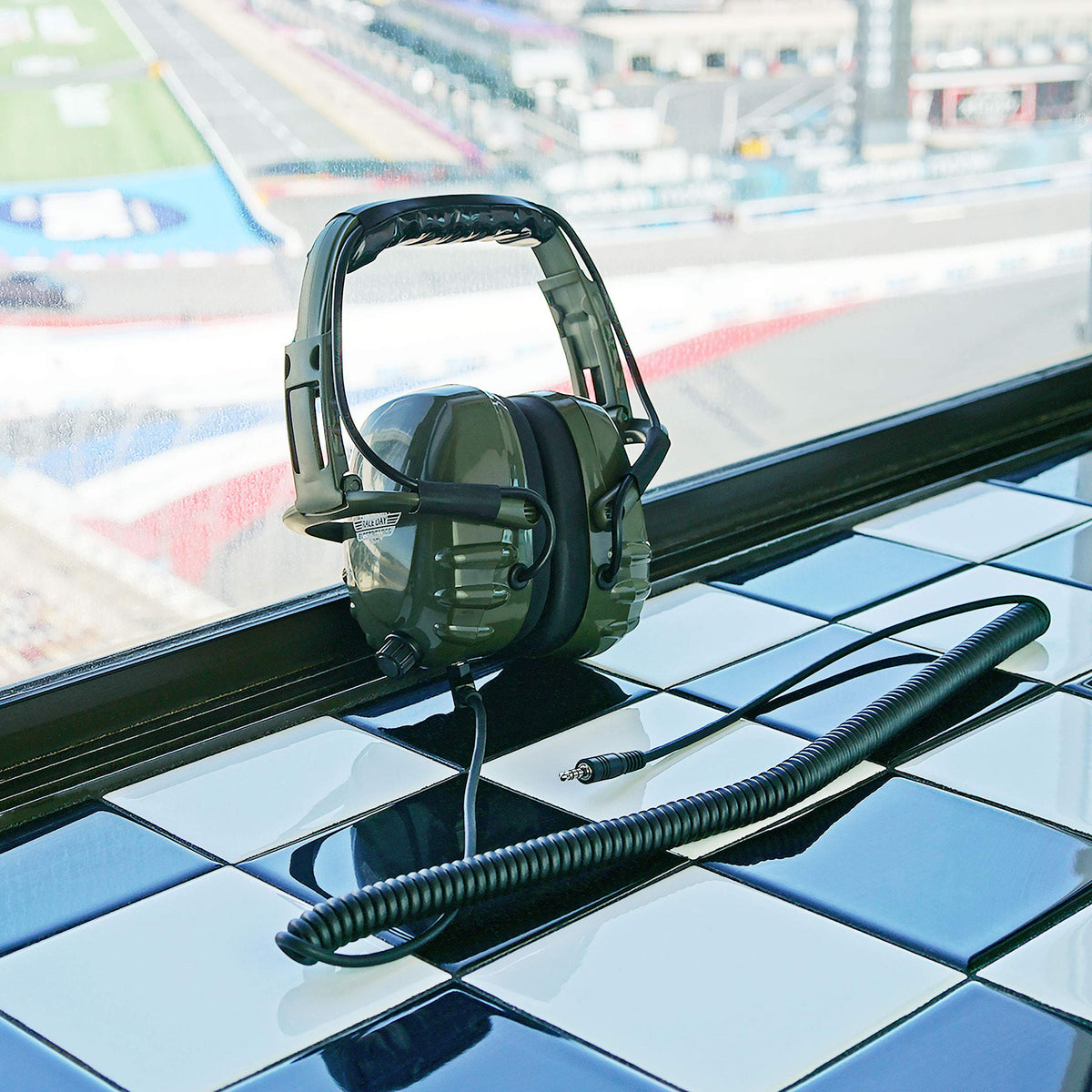 Race Day Electronics RDE-990 beside smartphone to show scale and compatibility benefits