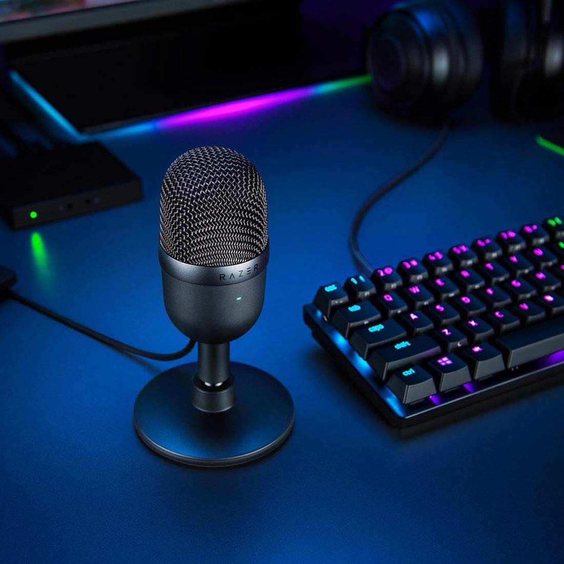 Razer Seiren Mini beside headphones and laptop for quick streaming setup benefit