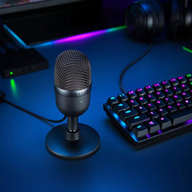 Razer Seiren Mini beside headphones and laptop for quick streaming setup benefit