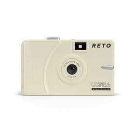 RETO camera front view in cream shows compact form for easy everyday carry.