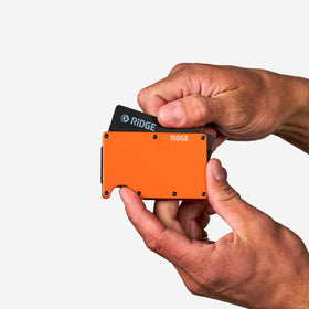 The Ridge Tracker Card next to credit cards to show slim size for effortless pocket carry