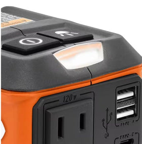 RIDGID inverter on a jobsite powering devices with toolbag and workbench background