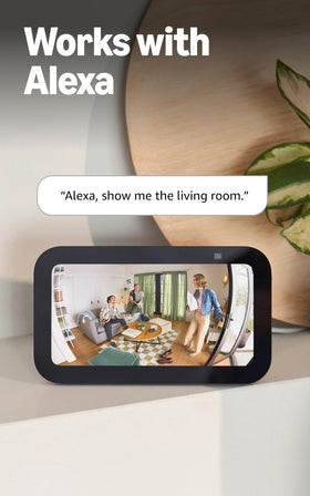 Ring Indoor Cam beside a hand to show scale, benefits compact and unobtrusive placement