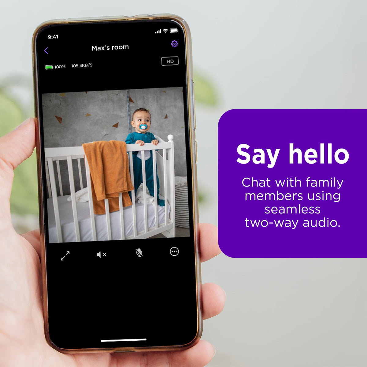Roku camera next to smartphone illustrating scale and easy mobile app control