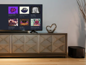 Roku onn subwoofer with Roku soundbar setup demonstrating seamless audio synchronization.