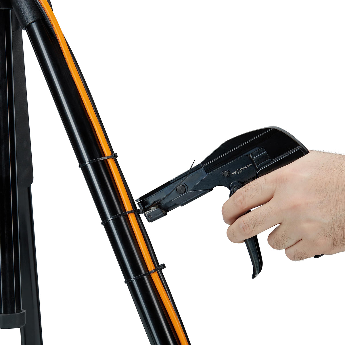 RV Rhodes zip tie gun tightening a cable bundle for organized wiring and secure fastening