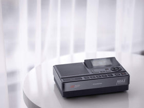 Sangean CL-100 next to AA batteries for scale, portable backup power benefit
