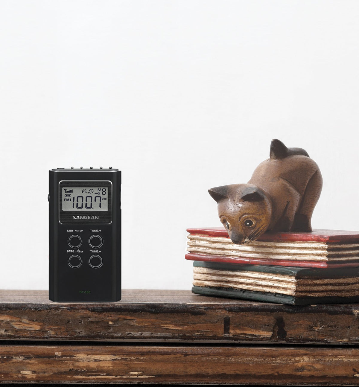 Sangean DT-180 with included earbuds and scale illustrating compact portability