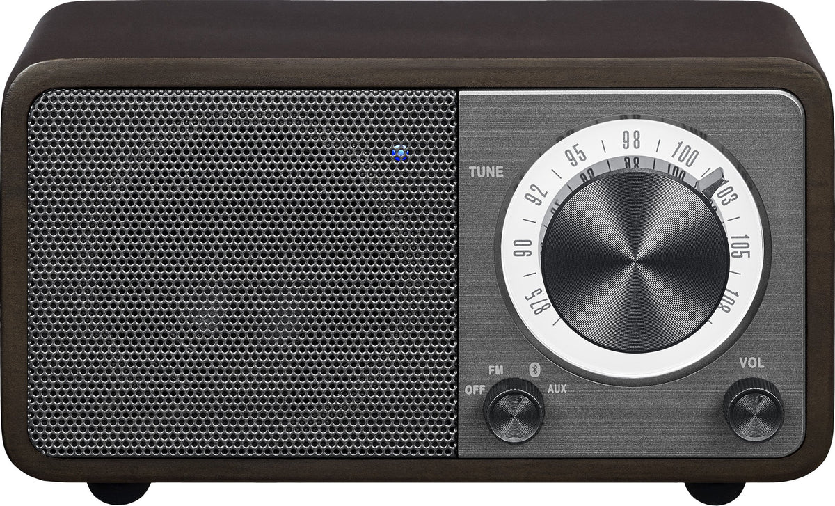Sangean WR-7DK front view with compact wood cabinet and warm ambience