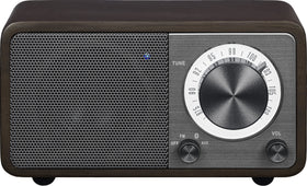 Sangean WR-7DK front view with compact wood cabinet and warm ambience