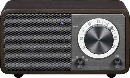 Sangean WR-7DK front view with compact wood cabinet and warm ambience