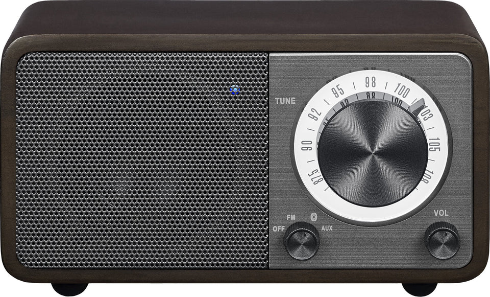 Sangean WR-7DK front view with compact wood cabinet and warm ambience