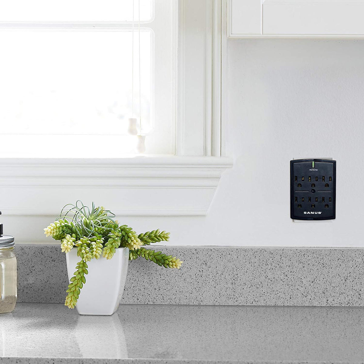 SANUS black-on-wall unit blends with entertainment centers for discreet protection.