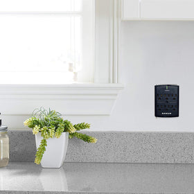 SANUS black-on-wall unit blends with entertainment centers for discreet protection.