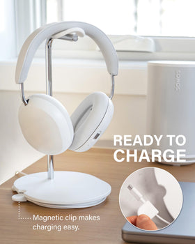 Sanus stand next to smartphone showing compact scale and space-saving design