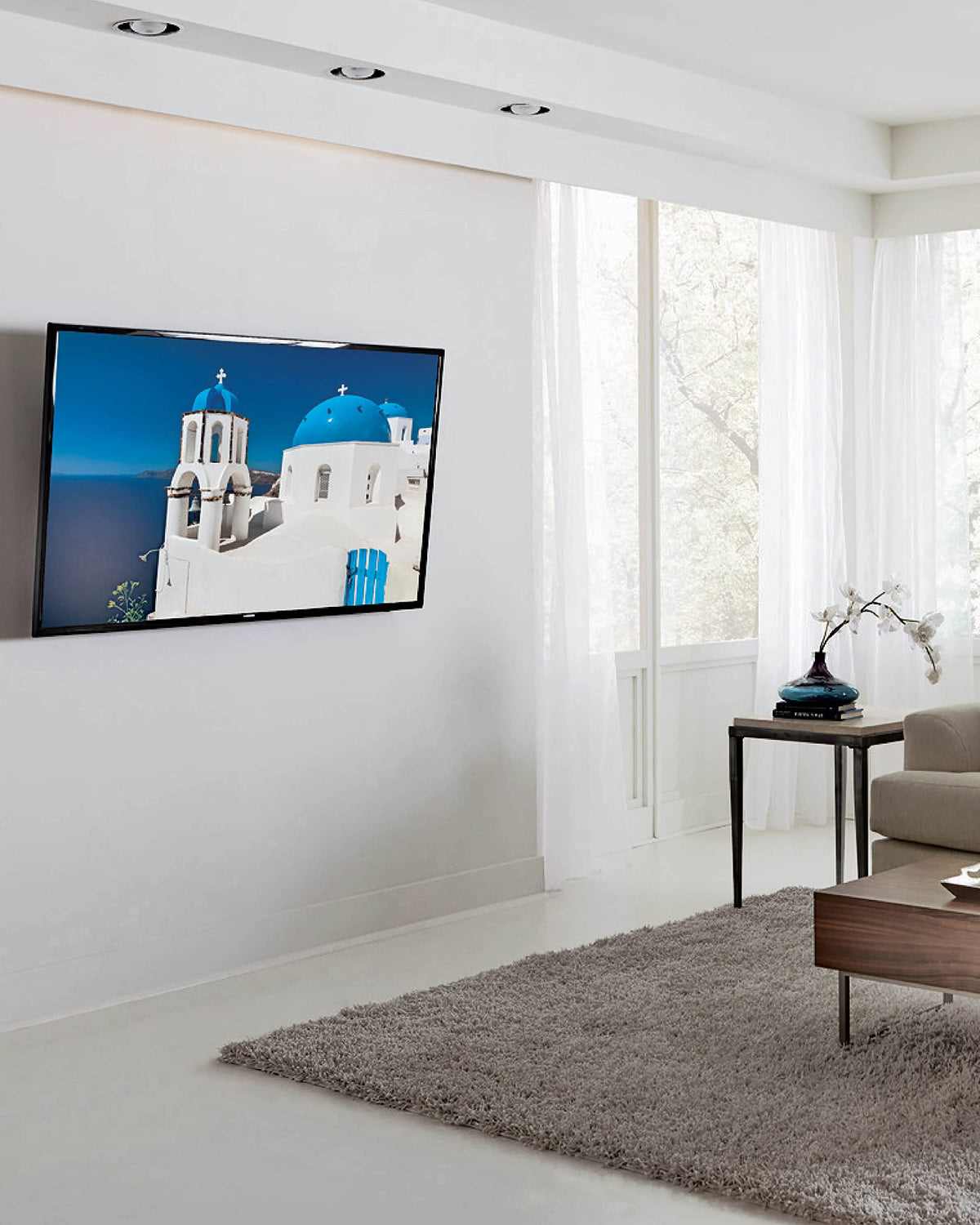 Sanus tilting mount showing a slim profile 2 inches from wall.