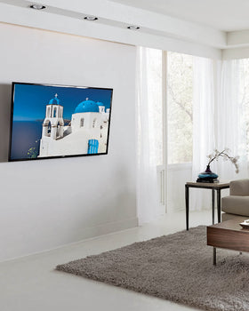 Sanus tilting mount showing a slim profile 2 inches from wall.