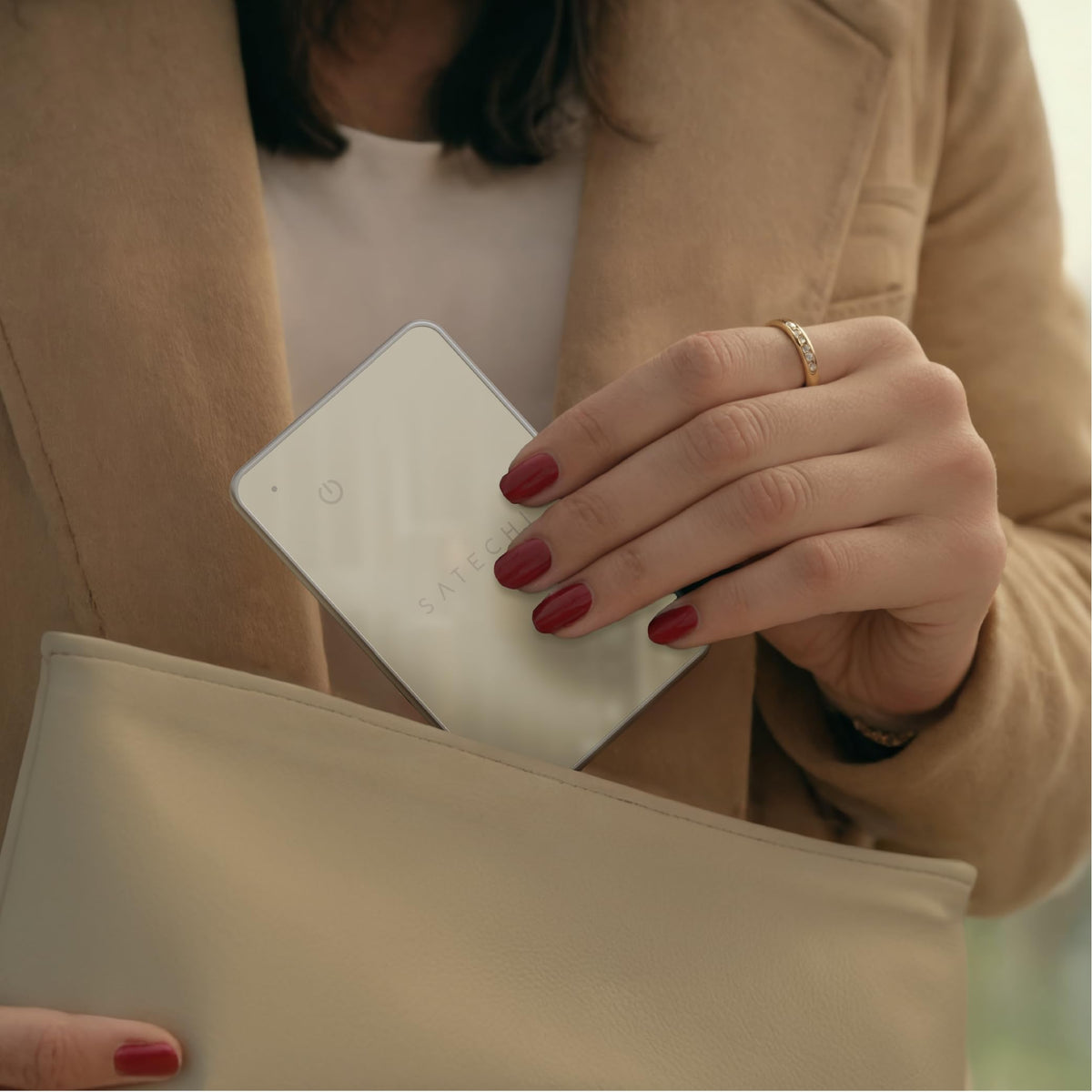 Satechi card inside a travel purse showing easy tracking for on-the-go peace