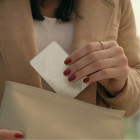 Satechi card inside a travel purse showing easy tracking for on-the-go peace