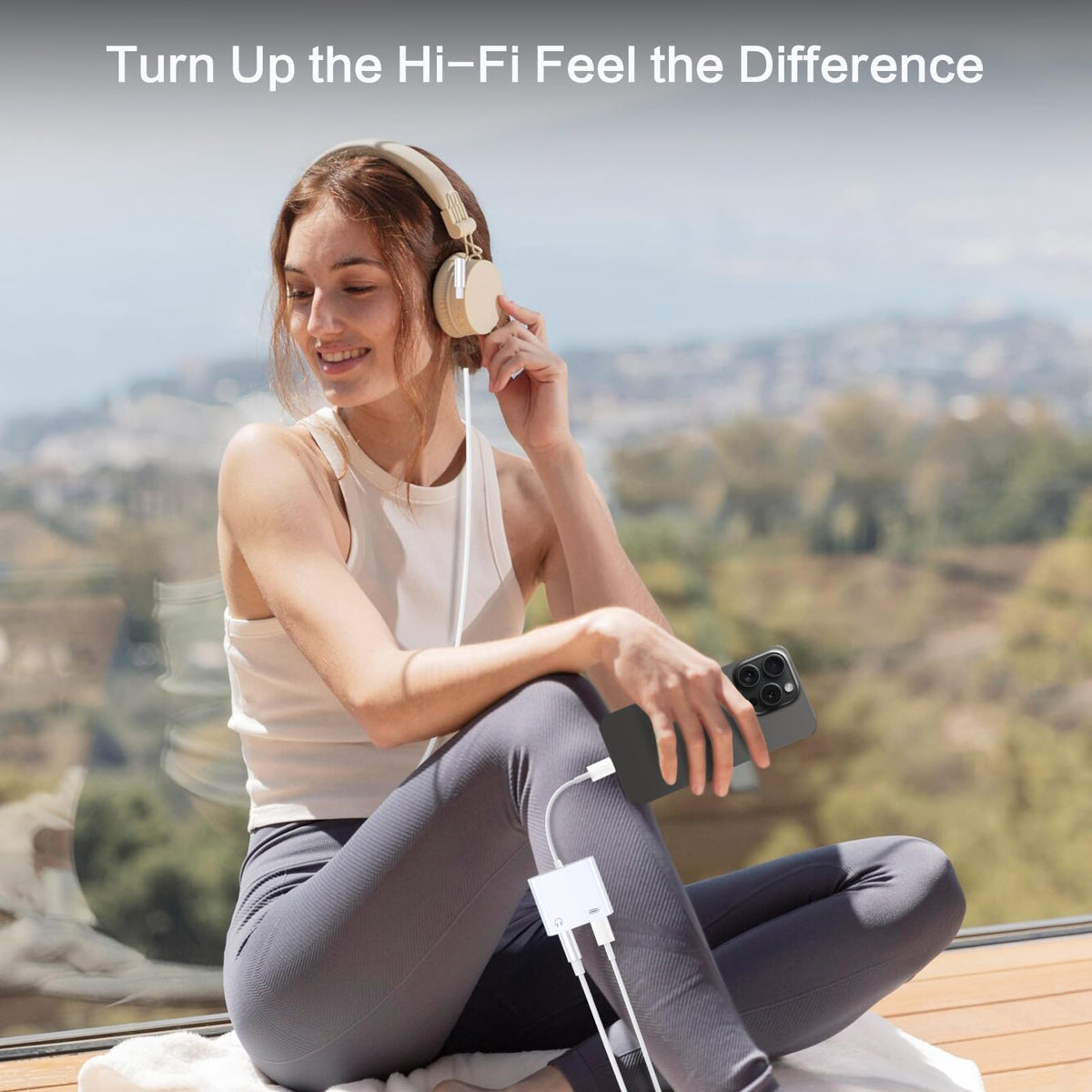 Seulliya adapter in use while charging and listening with headphones.