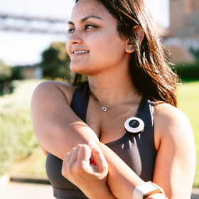 She's Birdie beside a key to show compact size and convenient portability