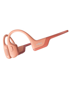 SHOKZ OpenRun Pro bone conduction headphones resting on a runner's cheekbone for open-ear awareness.