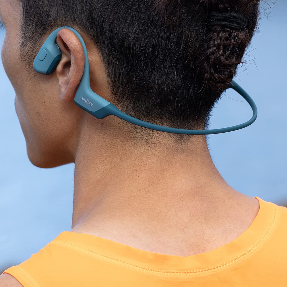 SHOKZ OpenRun Pro worn with hair band ensures secure fit during runs.