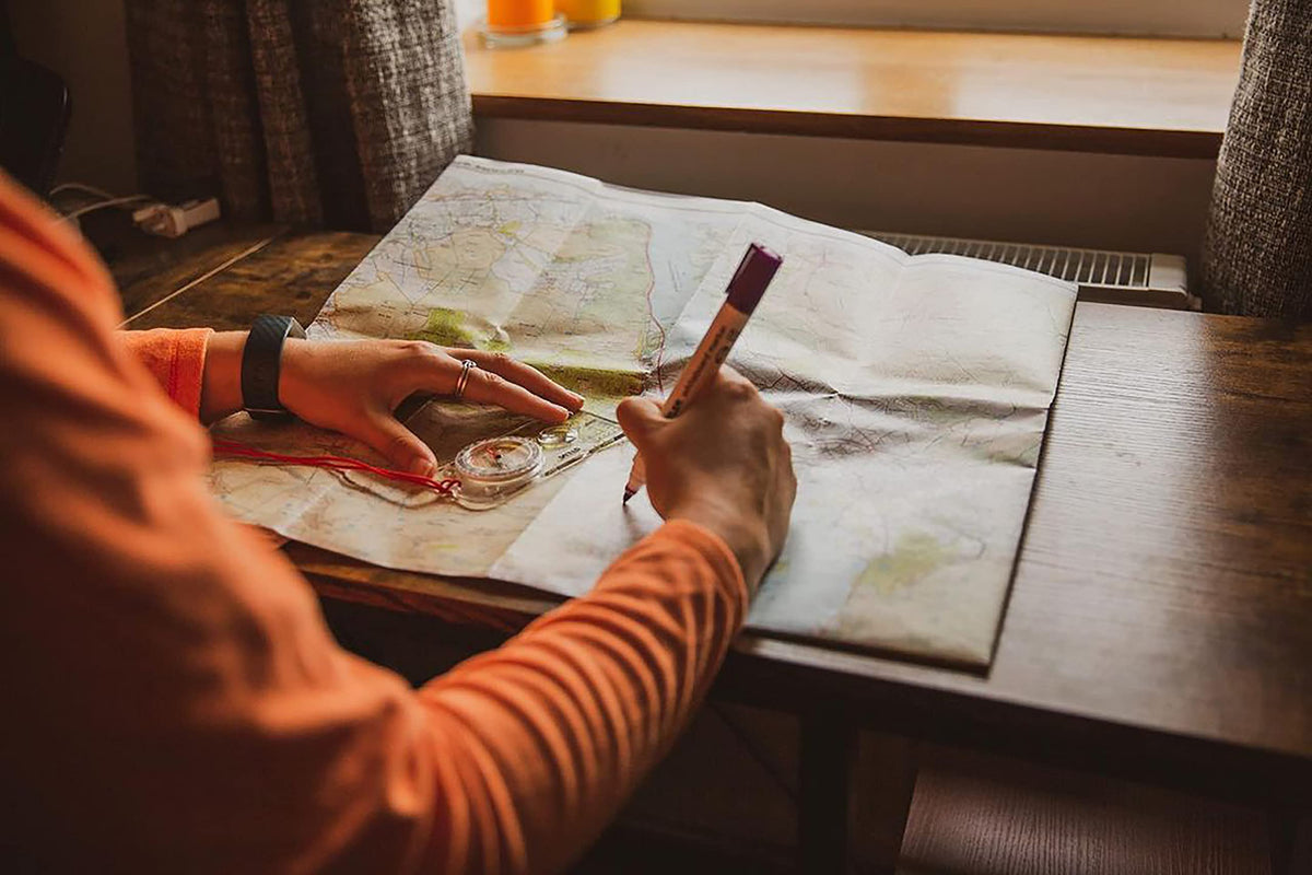 Silva Expedition 4 in-use with hiker plotting route and navigating rugged terrain