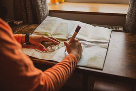 Silva Expedition 4 in-use with hiker plotting route and navigating rugged terrain