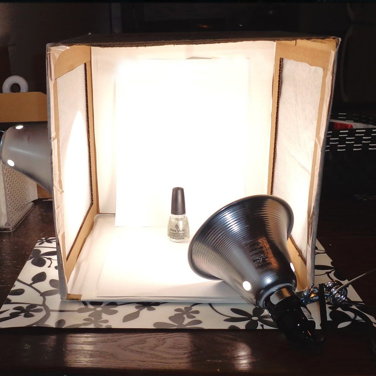 Simple Deluxe lamp brightening a photo studio setup for tasks.
