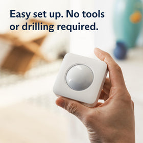 SimpliSafe motion sensor mounted in a room corner for wide coverage and fewer blind spots