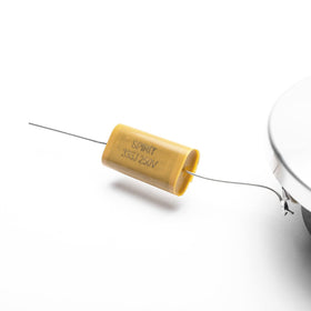 Skar Audio VX200-ST next to a coin for scale showing compact size that fits tight dash locations
